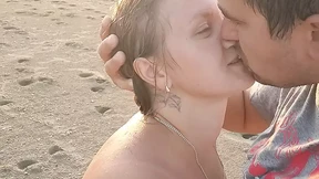 Hot couple on the Nudian beach enjoying handjob in the sea air