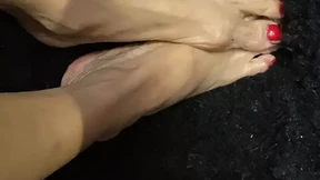 Oiled sexy tiny feet with red toenail polish