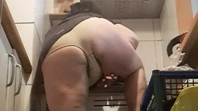 in the kitchen, relaxed, supported on her back