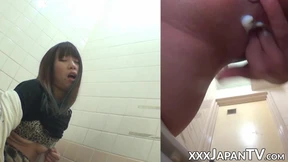 Naughty Japanese babe fingers her pussy in public toilet