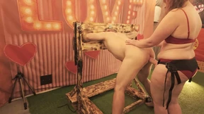 BDSM Mistress Pegging her slave in the stocks with a huge strapon
