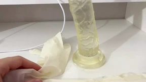I give a handjob to the dildo with oily hands in medical white gloves