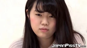  Asian beauty raises her skirt to display her pee session