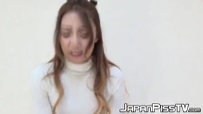 Oriental teen soaks her panties and the floor up with piss
