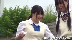 Outside pissing competition with two young Japanese pupils