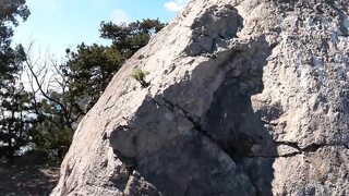 Outdoor Erotica, a Girl with a Stunning Figure Shows Her Magnificent Ass Against the Backdrop of the Sea and Mountains 